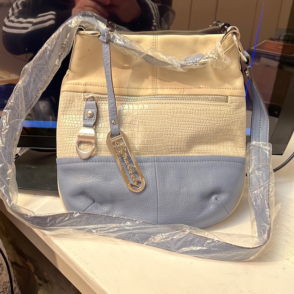 B. Makowsky white and blue leather bag